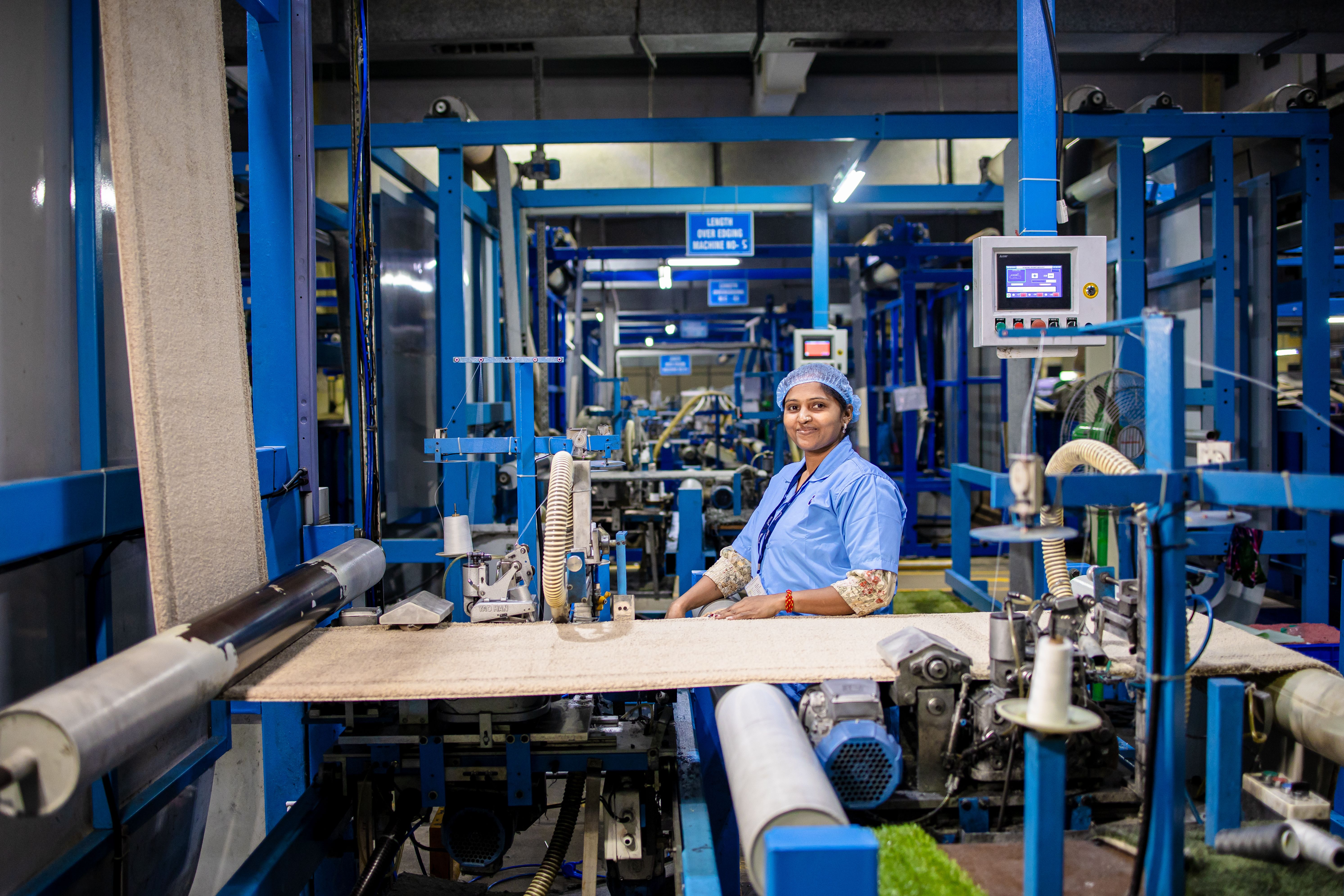 Operator at an edging machine line with a control panel